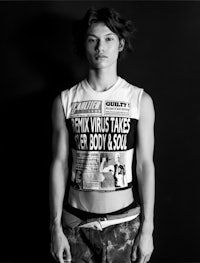 a black and white photo of a man wearing a t shirt